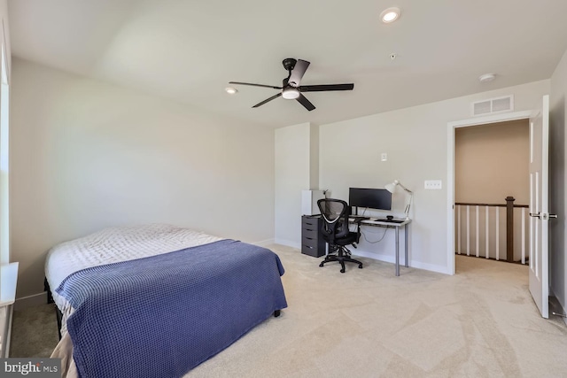 bedroom featuring baseboards, a ceiling fan, visible vents, and light colored carpet