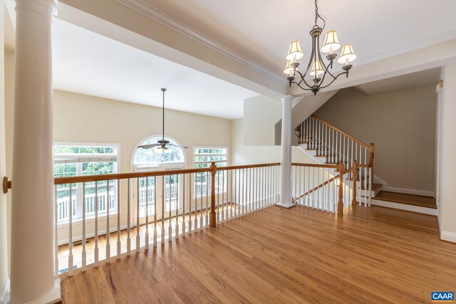 corridor featuring crown molding, a chandelier, and wood-type flooring