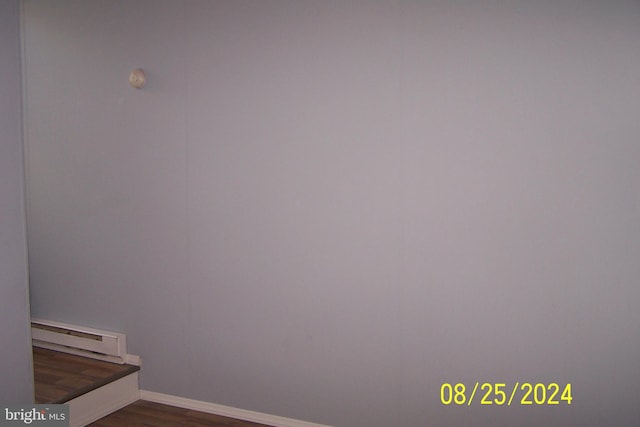 interior details featuring a baseboard radiator and wood-type flooring