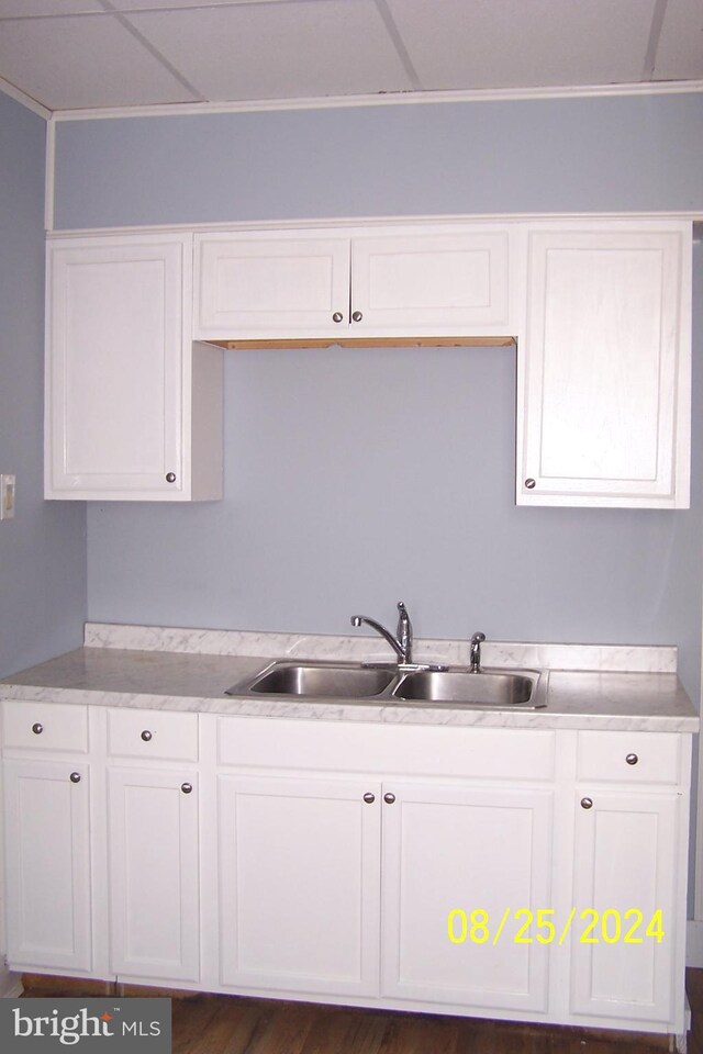 kitchen with white cabinetry, dark hardwood / wood-style floors, and sink