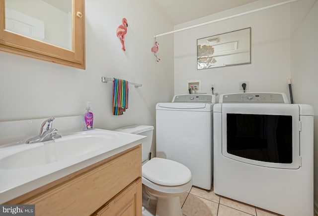 laundry area with washer and clothes dryer, sink, and light tile patterned flooring