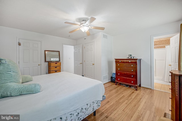 bedroom featuring connected bathroom, ceiling fan, and light hardwood / wood-style floors