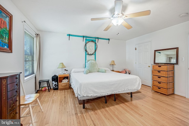 bedroom with ceiling fan and light hardwood / wood-style floors