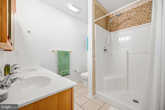 bathroom featuring vanity, toilet, walk in shower, and tile patterned flooring