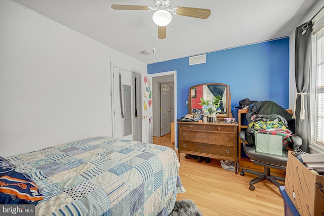 bedroom with ceiling fan and light hardwood / wood-style floors