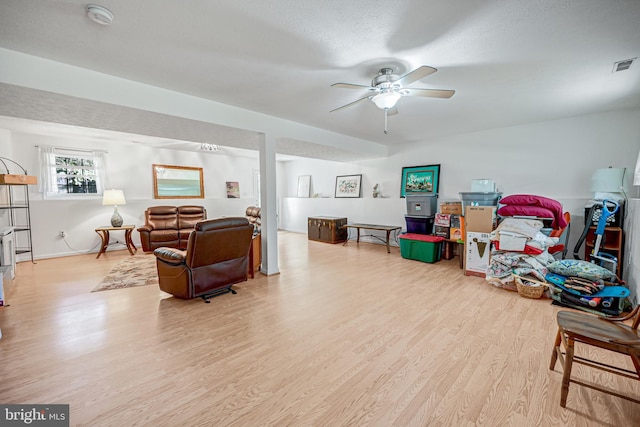 playroom with a textured ceiling, light hardwood / wood-style flooring, and ceiling fan