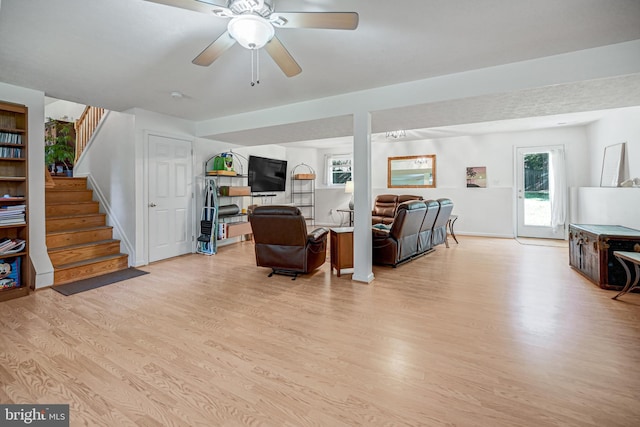 living room featuring light wood-type flooring and ceiling fan