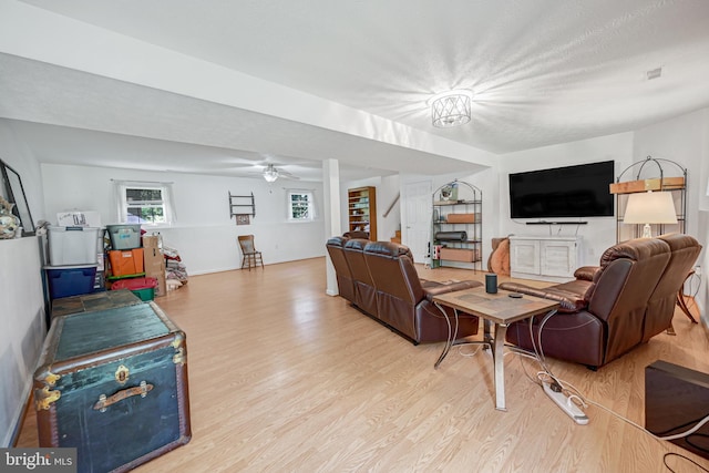 living room featuring light wood-type flooring and ceiling fan