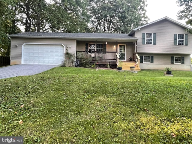 split level home featuring a garage, a front yard, and a porch