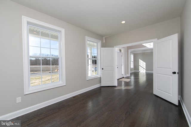 empty room featuring dark hardwood / wood-style flooring