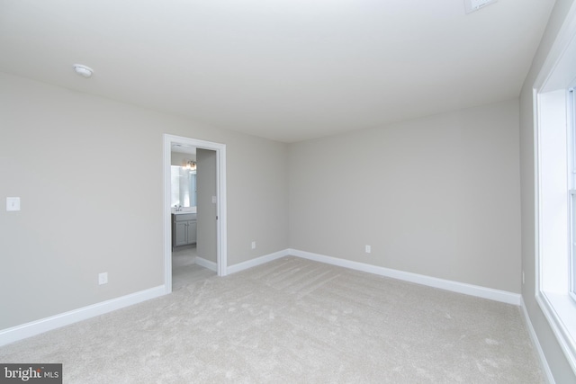 unfurnished room featuring light colored carpet