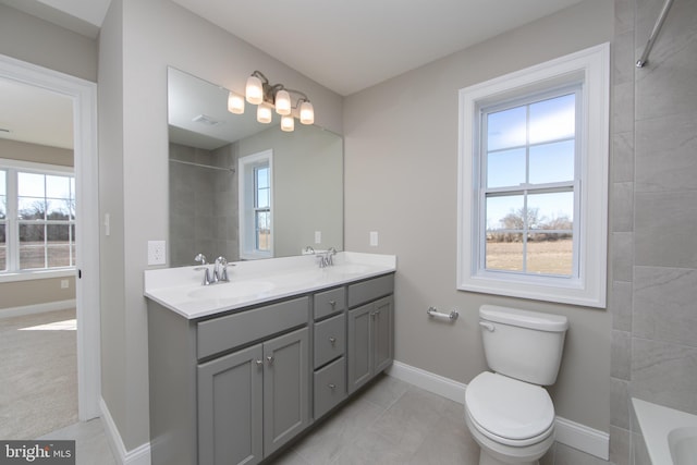 full bathroom with toilet, tiled shower / bath combo, tile patterned flooring, and vanity