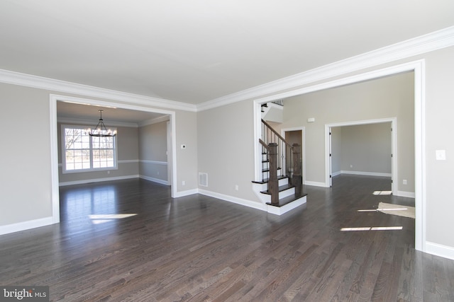 empty room featuring an inviting chandelier, dark hardwood / wood-style floors, and ornamental molding