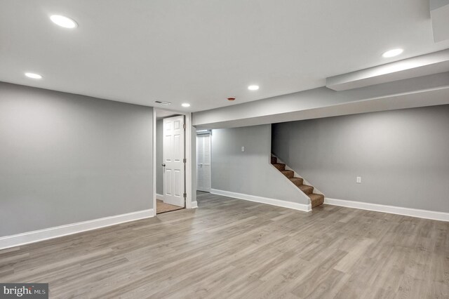 basement with hardwood / wood-style floors