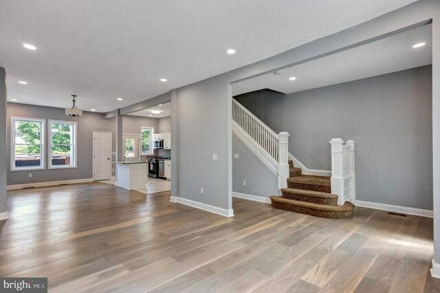 unfurnished living room with hardwood / wood-style flooring