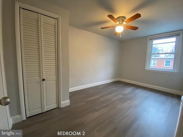 unfurnished bedroom featuring a closet, ceiling fan, and dark hardwood / wood-style floors