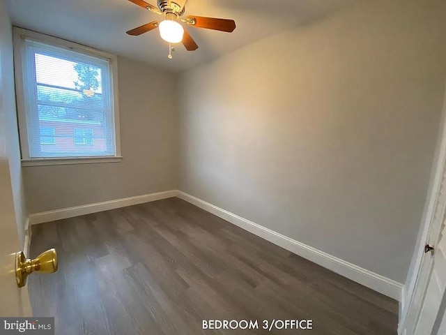 empty room featuring ceiling fan and dark hardwood / wood-style flooring