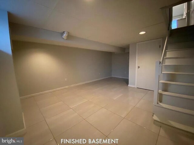 basement featuring light tile patterned floors