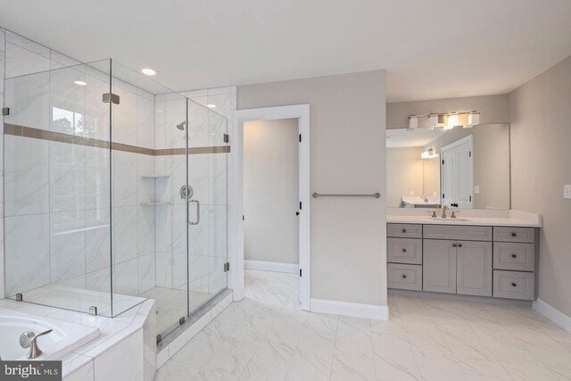 bathroom featuring tile patterned flooring, vanity, and shower with separate bathtub