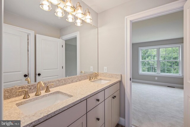 bathroom with vanity and a chandelier