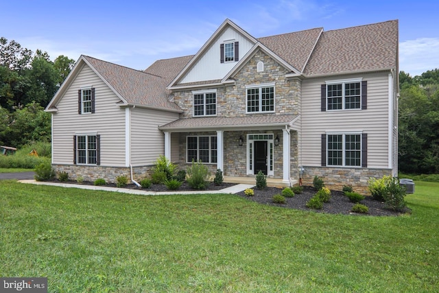 view of front facade with a front lawn and a shingled roof