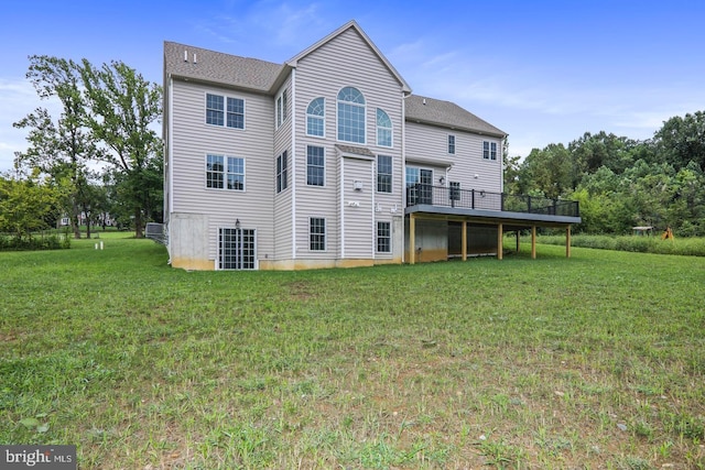 back of property with a lawn and a wooden deck