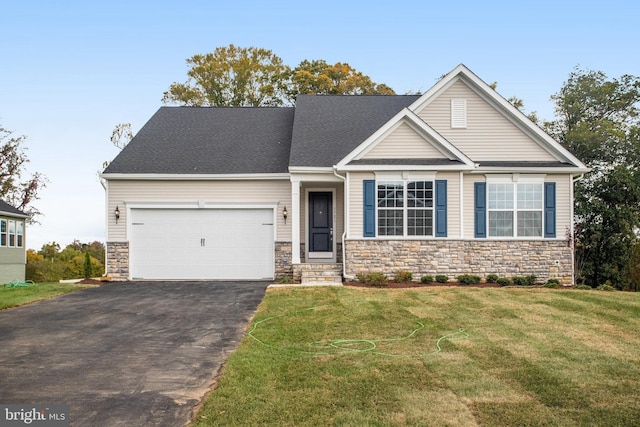 craftsman house with driveway, stone siding, a garage, and a front yard