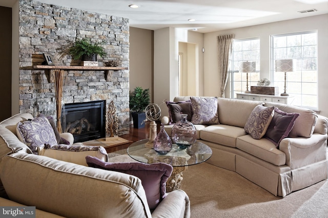 living room featuring wood-type flooring and a fireplace