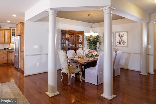 dining room with ornamental molding, dark wood-type flooring, and a chandelier