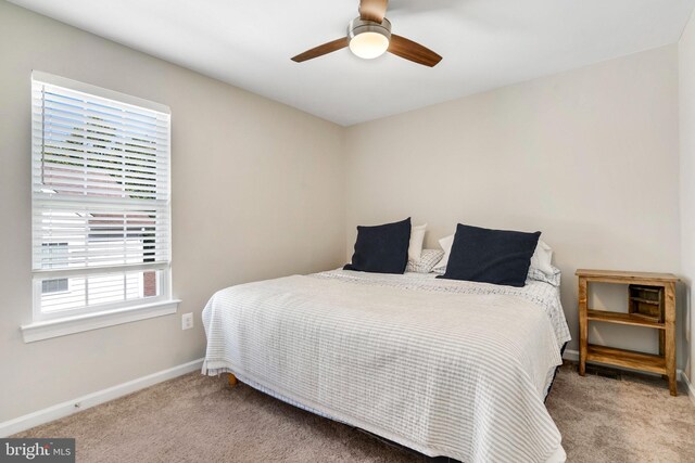 carpeted bedroom with ceiling fan and a closet