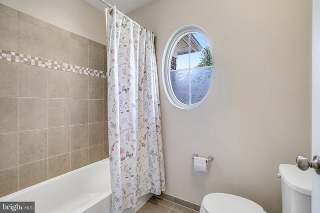 bathroom featuring shower / bath combo, tile patterned floors, and toilet