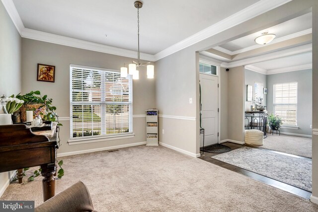 living area with ornamental molding, a chandelier, and hardwood / wood-style floors