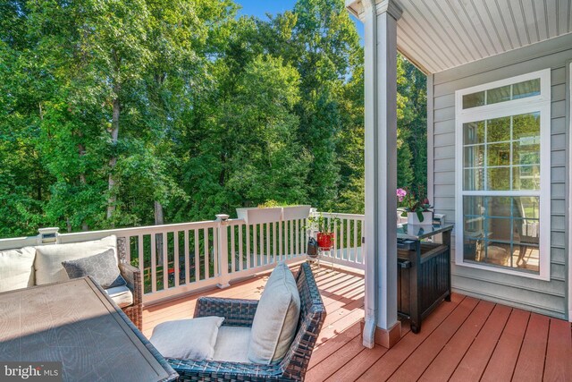 wooden terrace featuring an outdoor hangout area