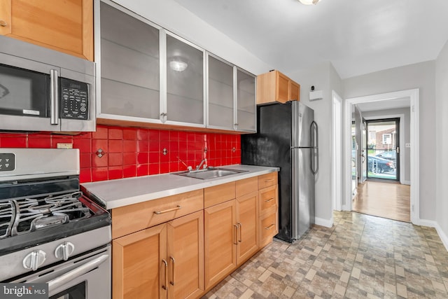 kitchen featuring tasteful backsplash, appliances with stainless steel finishes, and sink