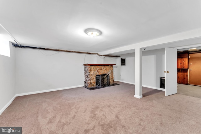 basement with a fireplace and carpet flooring