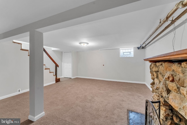 basement featuring stairs, carpet flooring, and baseboards