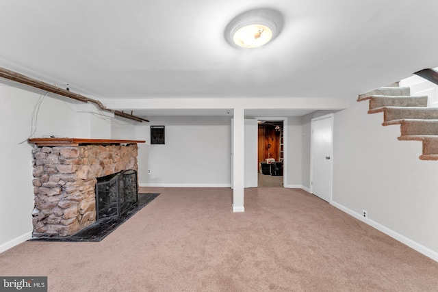 basement with a fireplace and carpet flooring