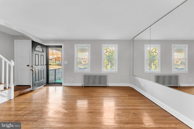 foyer entrance featuring radiator and light wood-type flooring