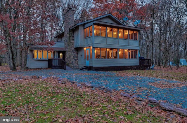 back of house with a sunroom