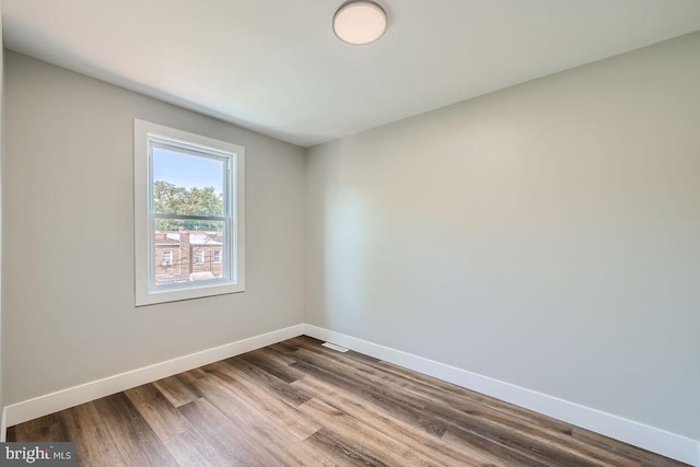 empty room with hardwood / wood-style flooring