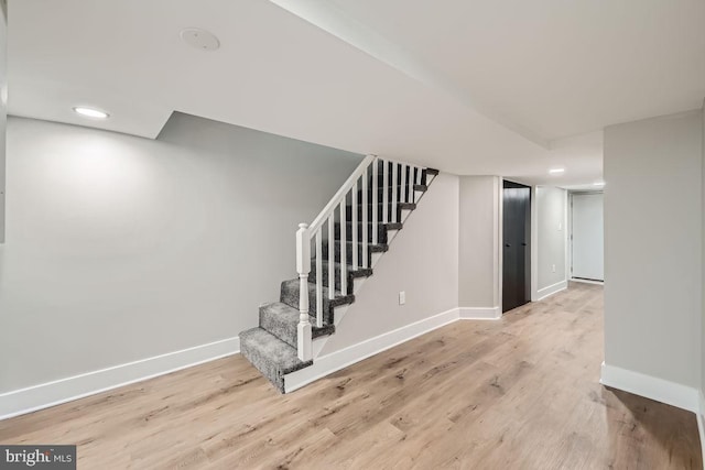 stairs featuring hardwood / wood-style flooring