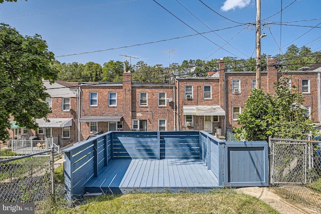 rear view of property featuring a wooden deck