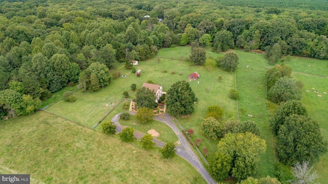 drone / aerial view featuring a rural view and a wooded view