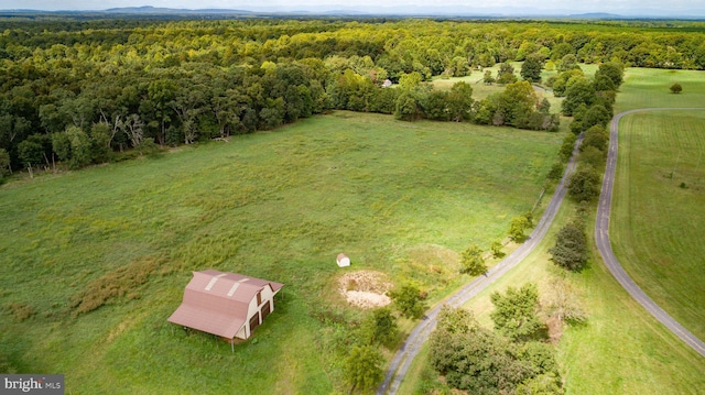 birds eye view of property with a rural view and a wooded view