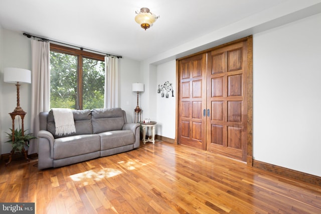 living area featuring baseboards and light wood-style floors