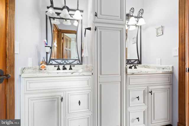 bathroom with vanity and an inviting chandelier