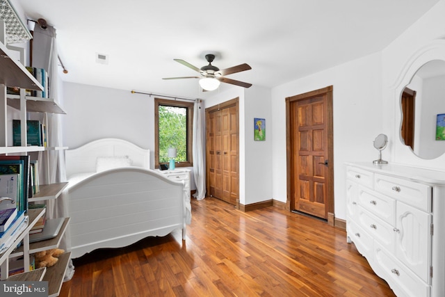 bedroom with visible vents, baseboards, ceiling fan, light wood-style floors, and a closet