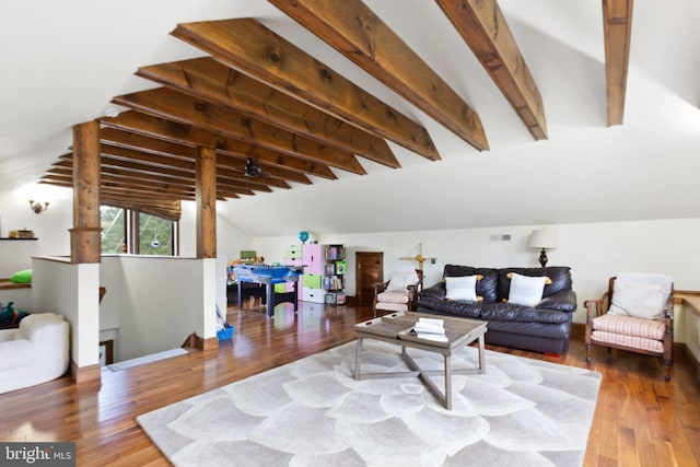 living room featuring lofted ceiling with beams and wood finished floors