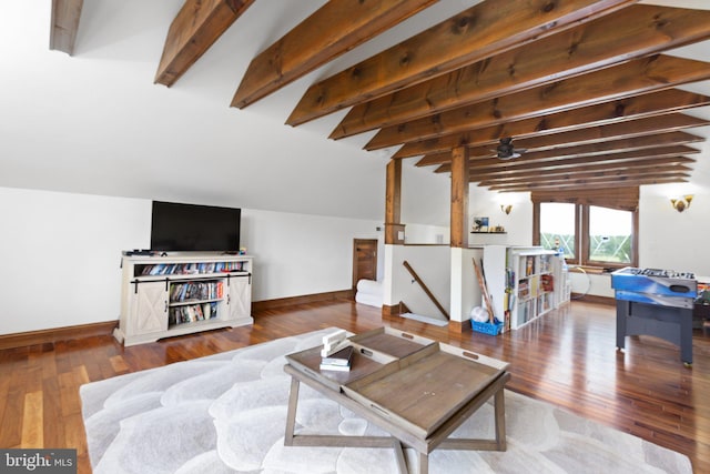 living room featuring lofted ceiling with beams, baseboards, and wood finished floors