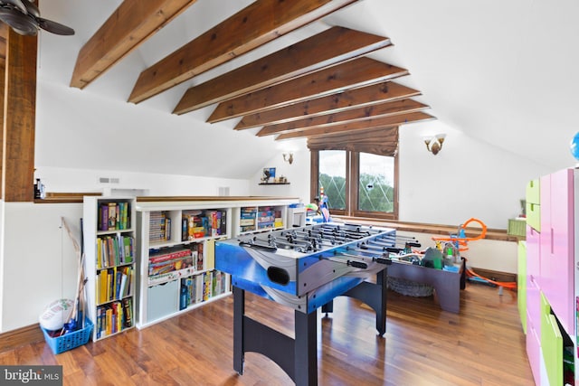 playroom featuring visible vents, vaulted ceiling with beams, and wood finished floors